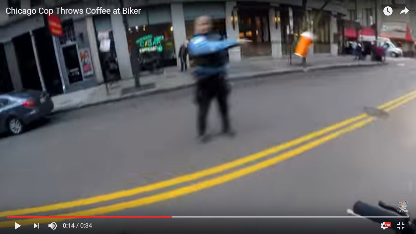 Video: cop throws coffee at biker